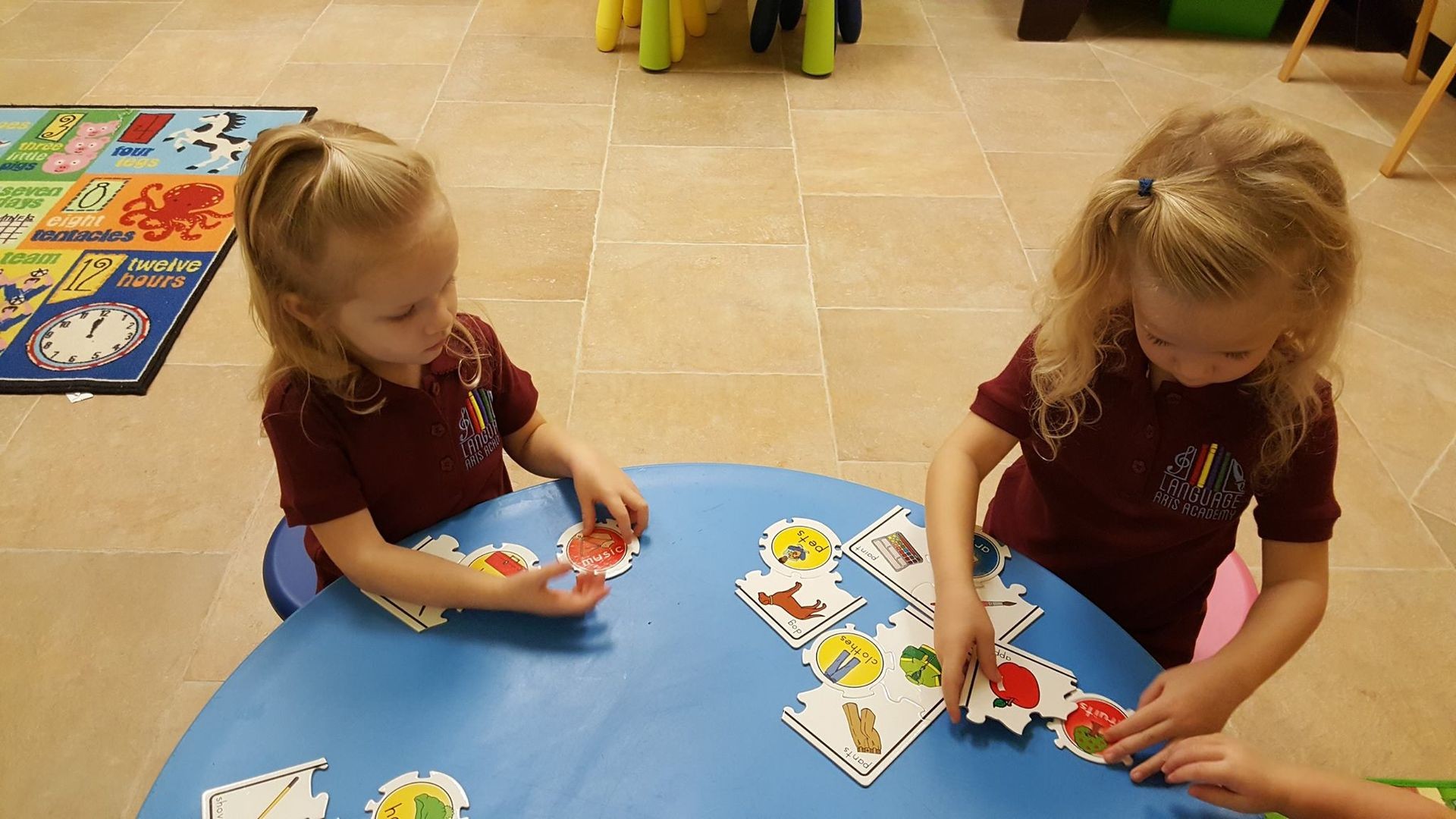 two girls playing a board game in Language Arts Academy Spanish Montessori Spring and Tomball Texas